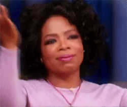 Video gif. Oprah Winfrey claps her hands together, folded under her chin, as she closes her eyes and looks grateful. 
