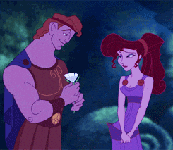 Disney gif. Hercules gives Megara a white flower and kisses her on the cheek.