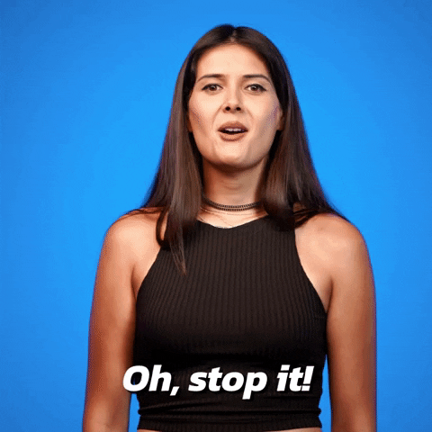 Video gif. A woman playfully shakes her head and says, “Oh stop it!”