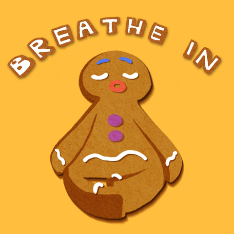 Digital art gif. An animated gingerbread man sits in lotus position with its legs crossed. He puffs up as he breathes in, then deflates as he breathes out. Text, "Breathe out."