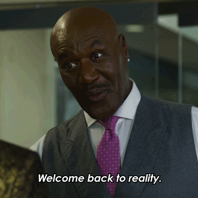 TV gif. Delroy Lindo as Adrian in The Good Fight smiles and says, “Welcome back to reality.”