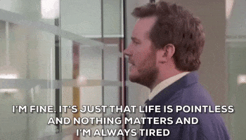 Parks and Recreation gif. Actor Chris Pratt as Andy Dwyer on Parks and Recreation stares listlessly through an interior window while saying "I'm fine. It's just that life is pointless, and nothing matters, and I'm always tired."