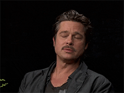 Celebrity gif. Brad Pitt is being interviewed and he chews gum slowly before taking a breath and turning his head, annoyed but amused.