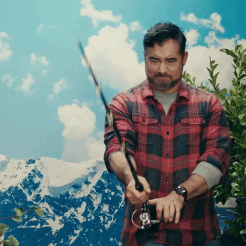 Sponsored gif. Gerald Downey holds a fishing pole in front of a snowcapped mountain landscape, yanking up repeatedly with great effort on the pole until a can of Busch Light beer attached to the lure pops into frame with a splash of water. Downey regards it with genuine surprise, then gives a satisfied nod. Text, "That'll do."