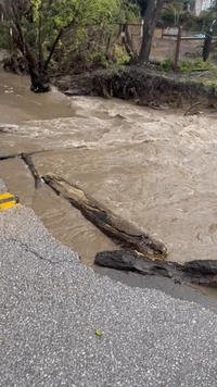 Creek Flows Over Washed-Out Road in California's Santa Cruz County