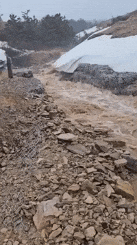 Road Washed Away as Heavy Rain Causes Flash Flooding