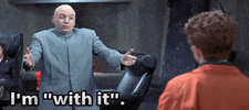 Movie gif. Mike Myers as Dr. Evil in Austin Powers puts out his arms and says "I'm with it, I'm hip," and then proceeds to do the macarena.