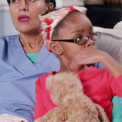 Video gif. A young girl wearing glasses and a head scarf puts her hand to her chest and leans back, her face an expression of extreme offense.