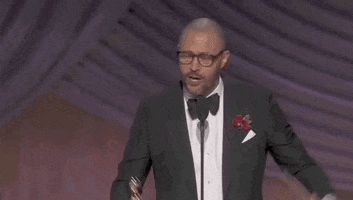 Oscars 2024 gif. Cord Jefferson, writer of American Fiction, raises his arms as he clutches the Oscars trophy and envelope and motions to the entire audience. Impassioned, he says, "This has changed my life. I love you all, thank you."