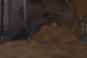 Music video gif. From the perspective of the pizza slice, a man's mouth chomps the pizza slice in SZA's music video, "Drew Barrymore."