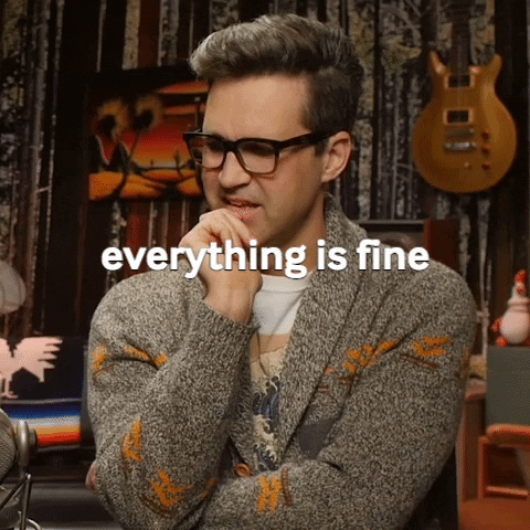 Video gif. Link, from Rhett and Link, scratches his chin contemplatively and laughs. Text, "everything is fine."