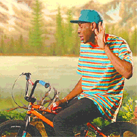 Celebrity gif. Sitting on an orange mountain bike, Tyler the Creator taps his foot and holds his hand behind his ear to gesture that he can't hear.