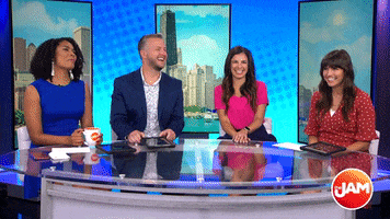 TV gif. A group of four TV anchors on The Jam laugh together.