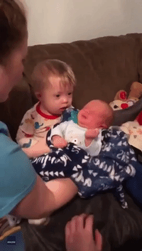 With a Little Help From His Aunt, Toddler With Down Syndrome Holds Baby Cousin for the First Time