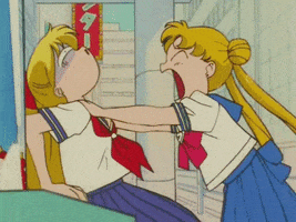 Anime gif. Sailor Moon grabs a friend by the shoulders and whips her around angrily, as her friends eyes roll back from the force.