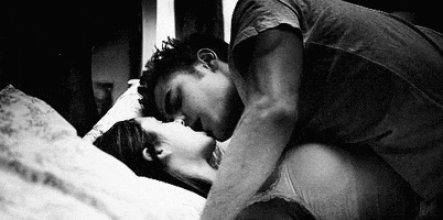 kiss in bed love GIF