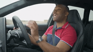 Video gif. Rory Reid on Autotrader's YouTube channel, sits in the driver's seat as we see countryside passing by in the background. He looks ahead as he gesticulates with a hand and says emphatically, "absolutely massive."