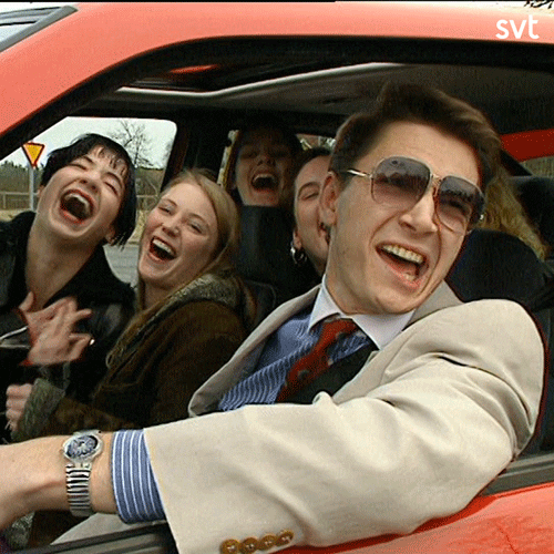 TV gif. A car full of people looking out and laughing.
