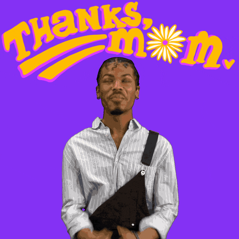 Digital art gif. Man wearing overalls with one strap undone clasps his hands together in a prayer motion and looks toward the sky thankfully, mouthing "thanks." Yellow text above him reads, "Thanks, Mom," with a spinning yellow flower in place of the "o" in "Mom," everything against a purple background.