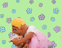 Cartoon gif. Sunnie Dee, a puppet, plants a big smooch on her pet bunny. They look at each other adoringly on a flowered background.