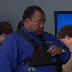 The Office gif. A disinterested Leslie David Baker as Stanley pulls a piece of pizza out of the triangular tablet case attached to his chest.