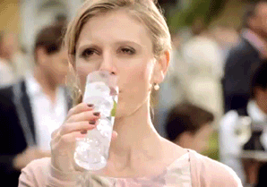 woman sipping a gin and tonic