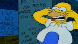 The Simpsons gif. Homer stands in front of a graffitied wall. He waves his hands in the air and shakes his head erratically like he is trying to scare someone away.