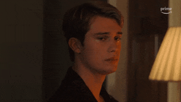 Video gif. Nicholas Galitzine as Prince Henry in Red, White, and Royal Blue. He's crying as he looks back over his shoulder 