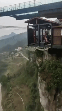 Brave Thrill-Seekers Ride Gravity-Defying Bike at Chinese Theme Park