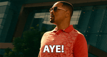 Movie gif. Will Smith as Mike in Bad Boys wears aviator sunglasses and leans back to shout, "Aye!" 