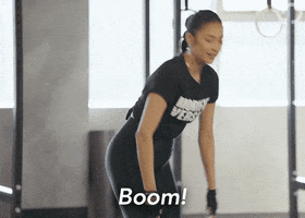 Celebrity gif. Shay Mitchell wears workout clothes and points ahead as if proving her point. Text, "Boom!"