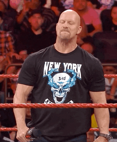 Sports gif. Stone Cold Steve Austin smiles with his eyes closed and lets his head hang as he listens to the cheering of the audience. He gives us a thumbs up while keeping his head down.