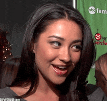 Celebrity gif. Shay Mitchell looks at someone sideways and nods slowly but eagerly. She inhales and bites her lips while nodding. 