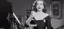 Movie gif. Bette Davis as Margo Channing in All About Eve raises her glass, proclaiming "amen!"