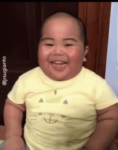 Video gif. A chubby baby is bouncing up and down from laughter. They slowly laugh and then fully crack up, looking around at everyone.