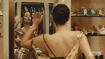 TV gif. Alexa Demie as Maddy in Euphoria. She's changing into different outfits and looking at herself in the mirror, pleased with her reflection. She waves at herself and grins with each outfit change.