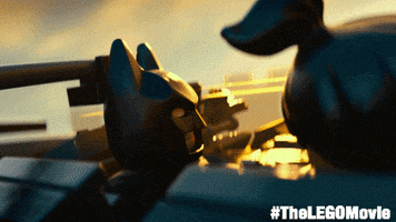 Movie gif. Lego batman turns to us and gives a heartfelt wink.