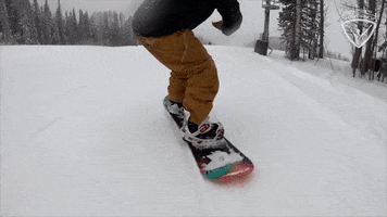 Sports gif. A snowboarder expertly rides down a slope, making tight turns that loop perfectly as the gif restarts.