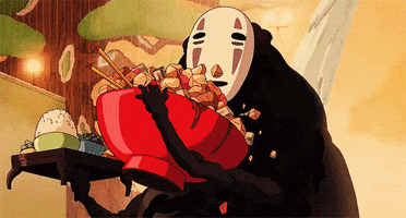 Anime gif. No Face from Spirited Away holds a large bowl of good and messily digs in, letting food and broth fall everywhere as he eats. In his other hand, he holds a small table with more food on it.