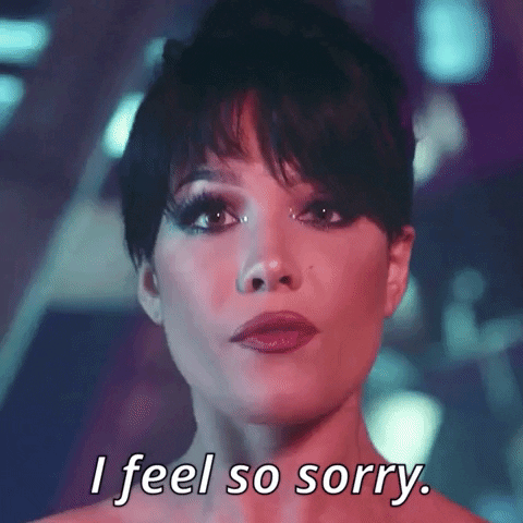 Music video gif. Singer Halsey, with wide eyes, makes eye contact and blinks, saying "I'm so sorry," from the video for the song "You Should Be Sad."