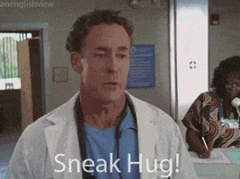 TV gif. Zach Braff as J.D. and John C. McGinley as Perry. J.D. runs and embraces Perry cheekily as he says, "Sneak hug!"