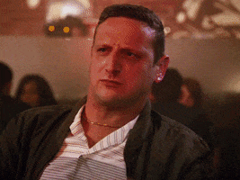 TV gif. Tim Robinson in I Think You Should Leave with Tim Robinson shields his eyes and perplexedly looks into the distance as the colors of police car lights flash upon his face. Text reads, "What the heck."