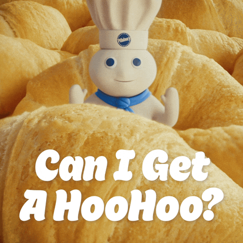 Sponsored gif. The Pillsbury Doughboy, in his iconic blue scarf and Pillsbury chef hat, standing in front of an image of crescent rolls. He lifts his arms in a raising the roof gesture. Text: "Can I get a Hoo Hoo?" 