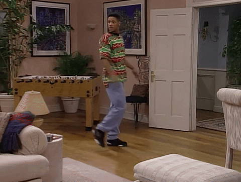 TV gif. Will Smith from Fresh Prince of Bel Air, goes to walk out of the room, but instead stops in his tracks, and spins in a complete circle. He looks at someone off screen and then points at himself as if saying, “who me?” 