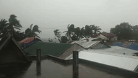 Batten Down The Hatches: Man Secures Roof as Tropical Cyclone Ursula Makes Landfall