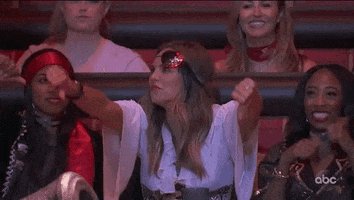Reality TV gif. Hannah Brown on the Bachelor sticks out her tongue and gives two thumbs down.