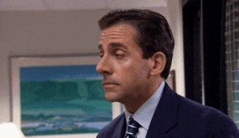The Office gif. Steve Carell as Michael Scott slowly turns with eyebrows raised and walks into his office.