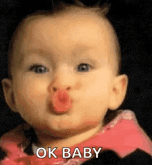 Video gif. A baby gives a kissy face as its eyebrows raise. Text, "OK baby."