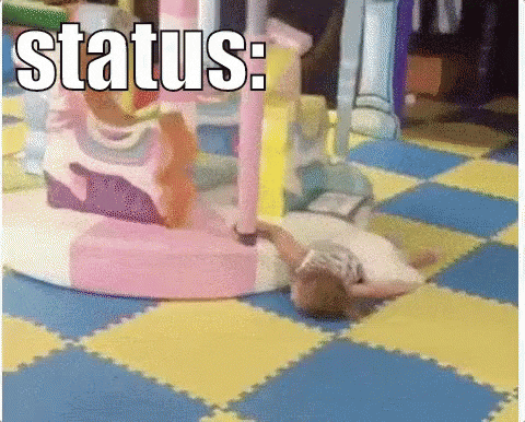 a little girl is laying on the floor in a playground .