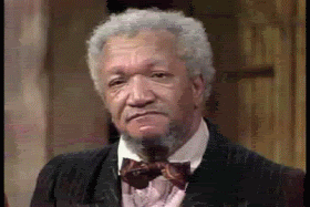 TV gif. Red Foxx as Fred Sanford in Sanford & Son shakes his head in disapproval, then looks to man on his right, who looks to a man on his right, who looks to a man on his right, who settles into a groan of mild despair.